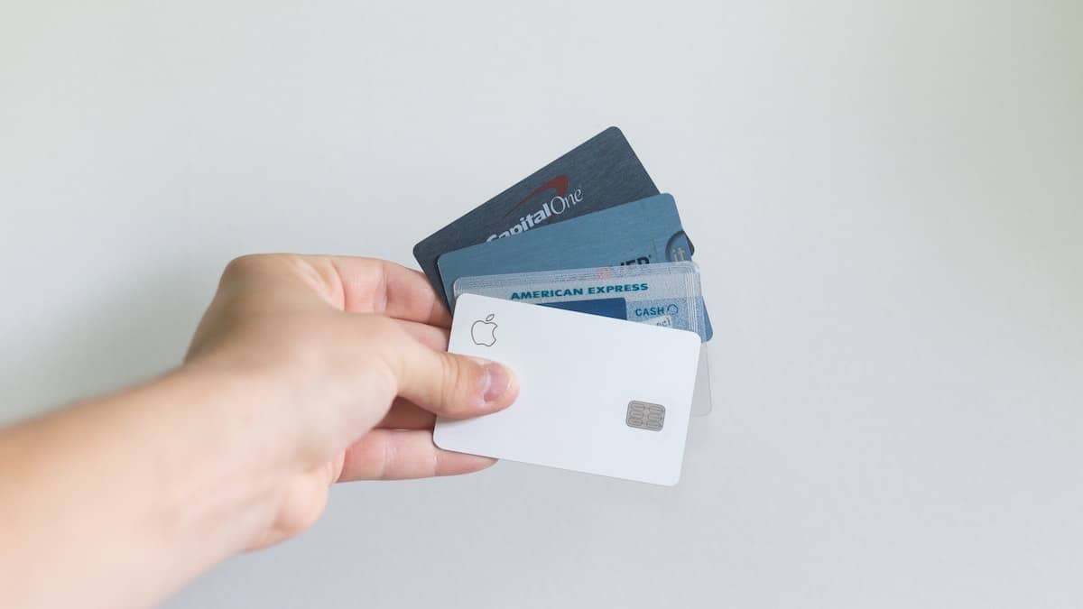 A hand holding a number of payment cards