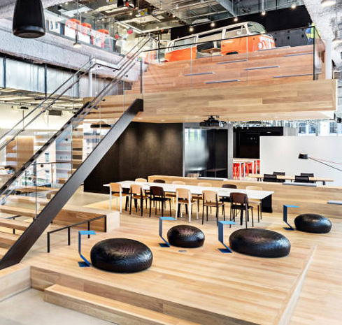 An open office includes cabins and a meeting section in the same space